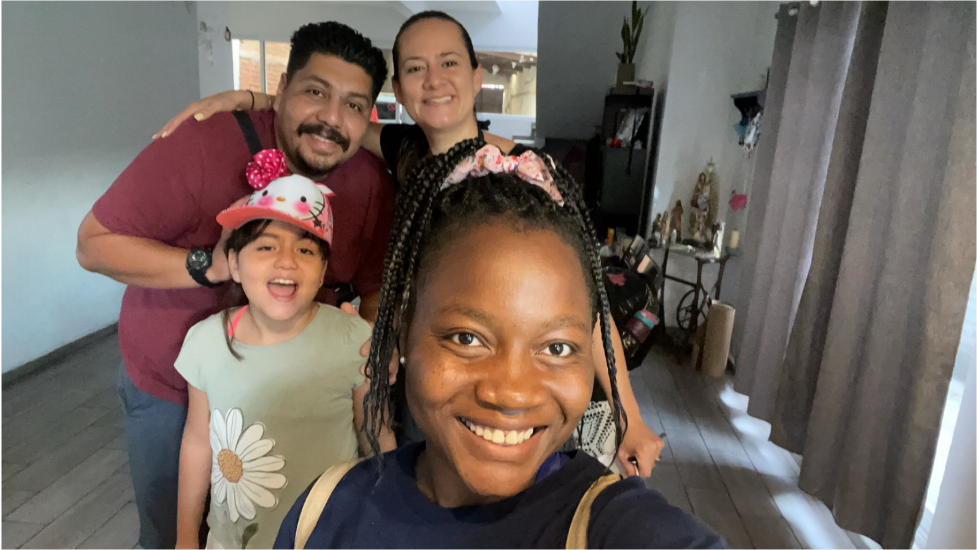 smiling student with host family in mexico